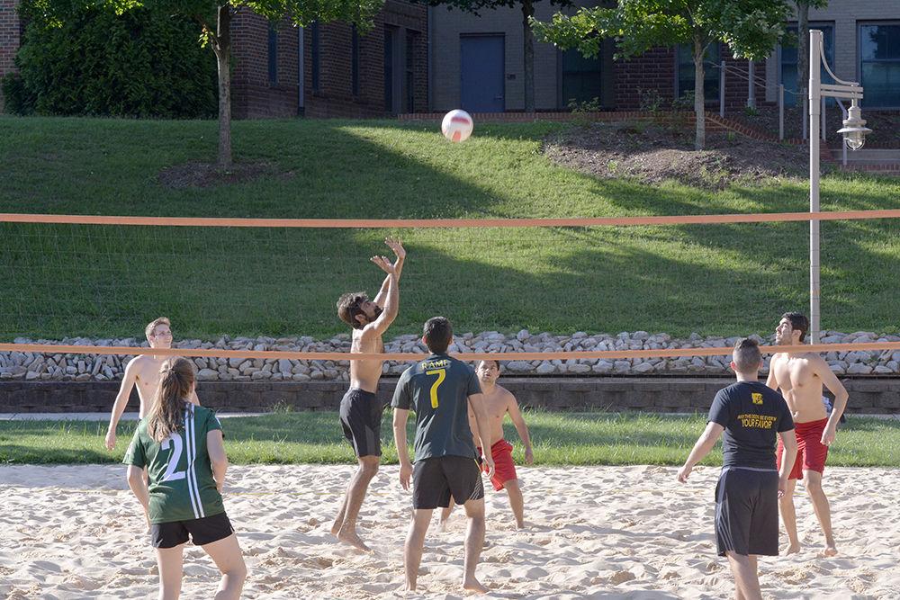 Players of teams Breakfast Is Served &amp; Areia Brazil play sand volleyball at Wolf Village on July 15, 2015. Tem Areia Brazil won the game. Sand volleyball is a part of intramural sports organized by University Recreation during the summers.&#160;