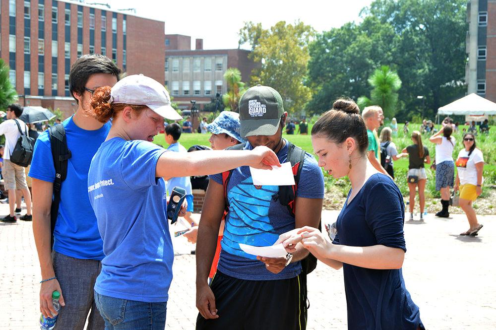 A group of students use the pinhole projectors to view the Solar Eclipse at the Brickyard on Monday, Aug. 21. These pinhole projectors were passed out throughout the solar eclipse festivities sponsored by the College of Sciences.