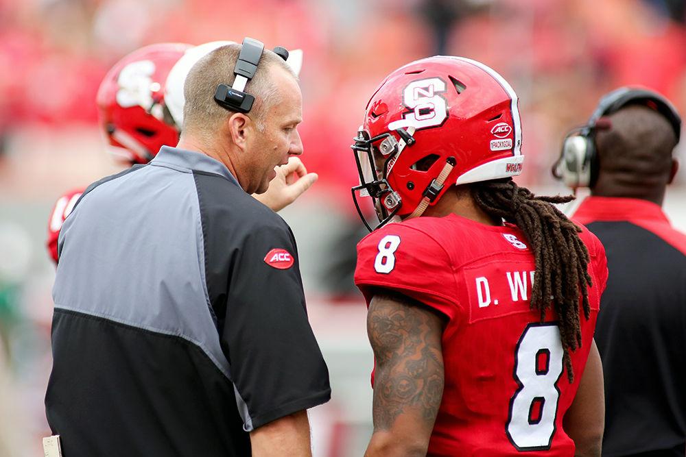 Head coach Dave Doeren talks to senior nickleback Dravious Wright during a timeout. The error-prone Wolfpack fell to Maimi 27-13 on Nov. 19, 2016 in Carter-Finley Stadium.