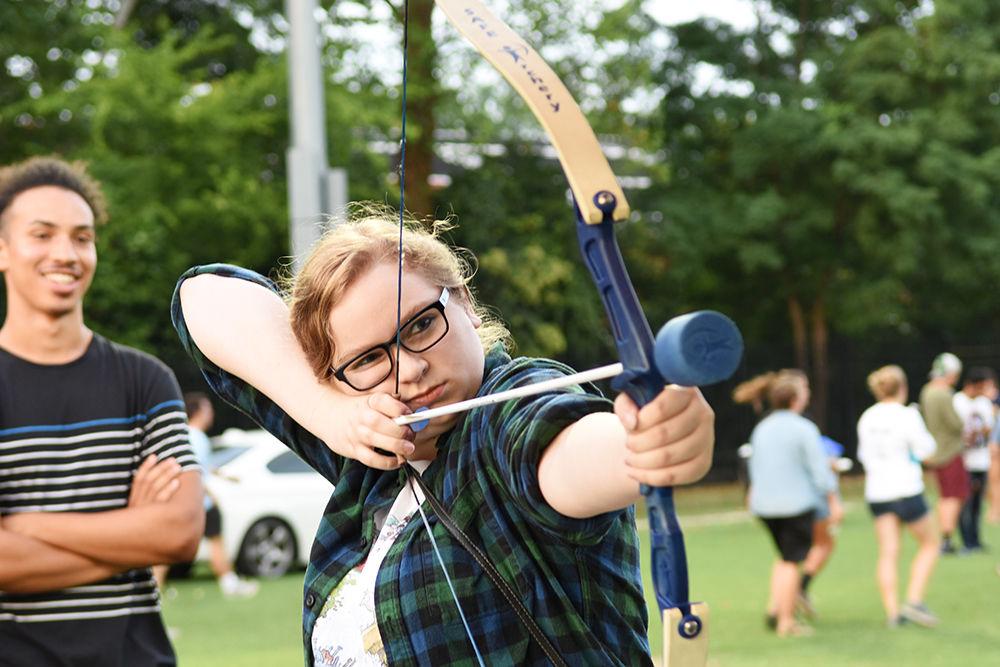 Jessica Hamm, a second-year studying materials science and engineering, pulls back a bow during a carnival-style game at this year's RecFest on Sunday on Miller Fields. The object of the game was to hit the targets floating in the air.