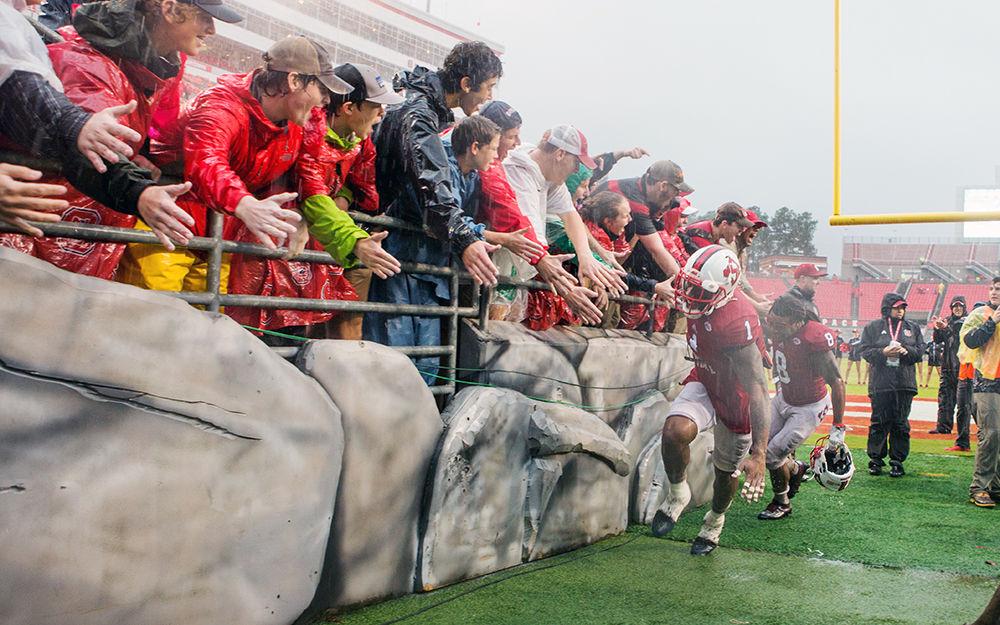 Junior tight end Jaylen Samuels and Senior nickelback Dravious Wright celebrate with fans on the way back into the tunnel after the 10-3 win over Notre Dame on Oct. 8, 2016 in Carter-Finley Stadium.
