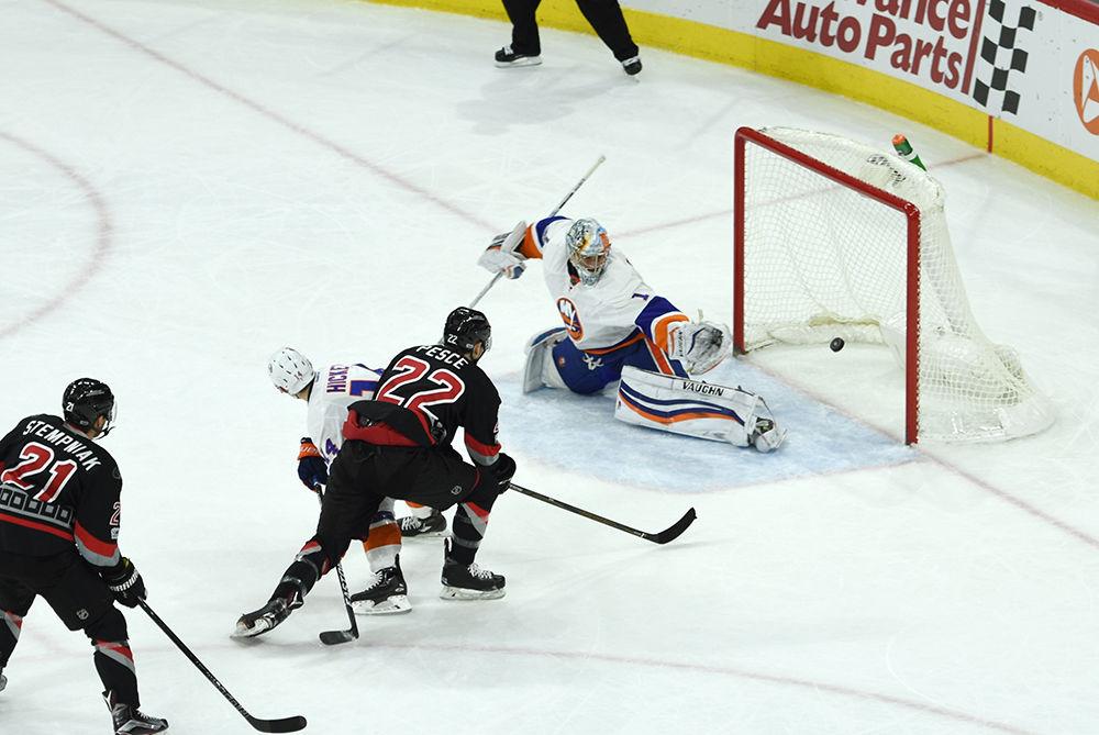 Hurricanes defenseman Brett Pesce nets a goal past Islanders goalie Thomas Greiss in the second period of the game on Saturday in PNC Arena. The goal marked Pesce's second of the season with an assist from forward Brock McGinn, his sixth of the season and first of three for the night. The Hurricanes defeated the Islanders by a score of 7-4.