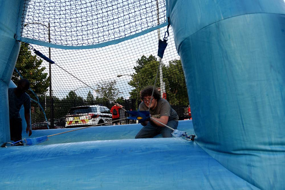 Paden Abernathy a first-year studying human biology pulls back a slingshot during a game at this year's RecFest on Sunday, August 13 on Miller Field. The object of the game was to hit the opposing team with wet sponges using the sling.