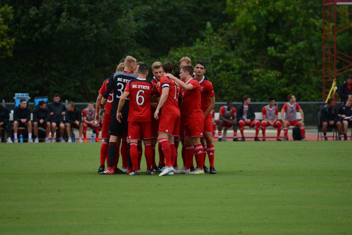 The NC State men's soccer team joins together for a group huddle before the start of the game. At the time this photo was taken the NC State men's soccer team was winning 1-0 against LIU Brooklyn at Dail Soccer Stadium on Friday, Sep. 1 until the game was suspended due to inclement weather.
