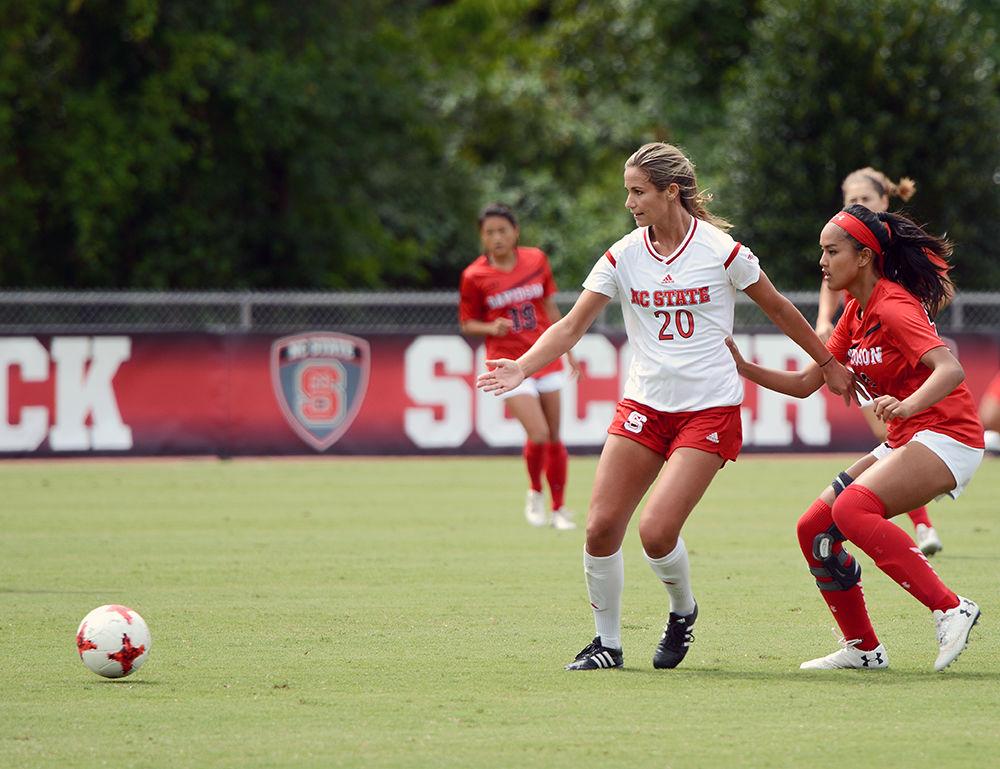 Redshirt-Senior forward Rachel Cox passes the ball and calls for another player to step up to receive the pass. The NC State women's soccer team beat Davidson 4-0 at Dail Soccer Stadium on Sunday, Sept. 10.