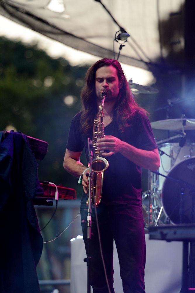 A band member performing with Tei Shi adds some silky alto saxophone to Shi's eclectic track.&#160; Shi, a solo artist from Canada, performed with three additional band members, including and guitarist and drummer at Red Hat Amphitheater as part of Hopscotch 2017 on Saturday.