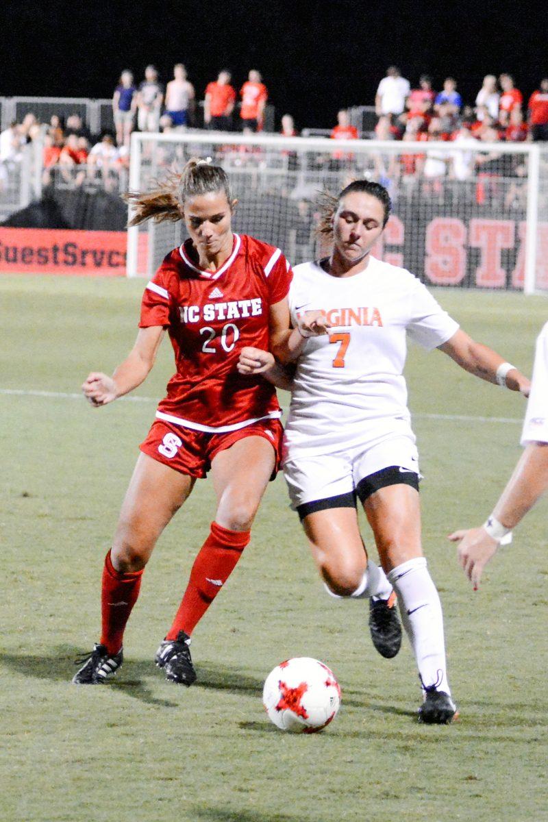 Redshirt-Senior forward Rachel Cox shoulders a Virginia player looking for possession of the ball. The NC State women's soccer team tied Virginia 0-0 in double overtime at Dail Soccer Stadium on Friday, Sep. 15.