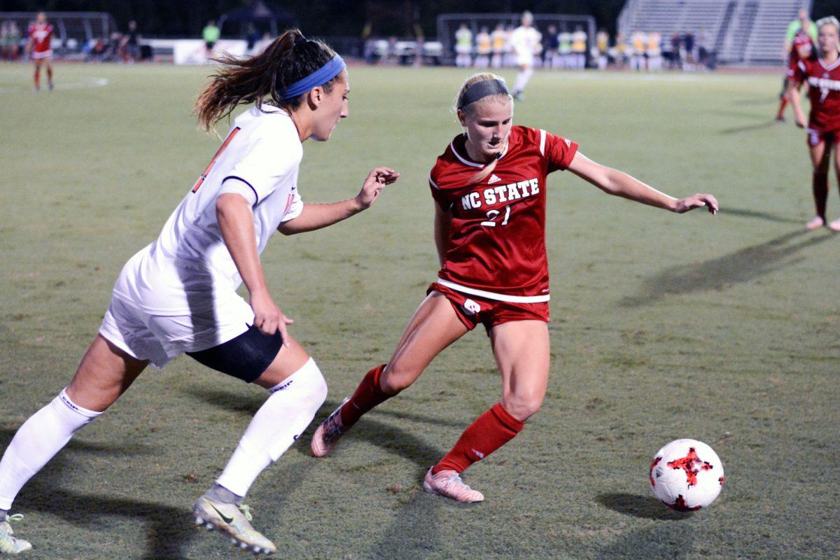 Sophomore midfielder Paige Griffiths sidesteps a Virginia player to make a pass. The NC State women's soccer team tied Virginia 0-0 in double overtime at Dail Soccer Stadium on Friday, Sep. 15.