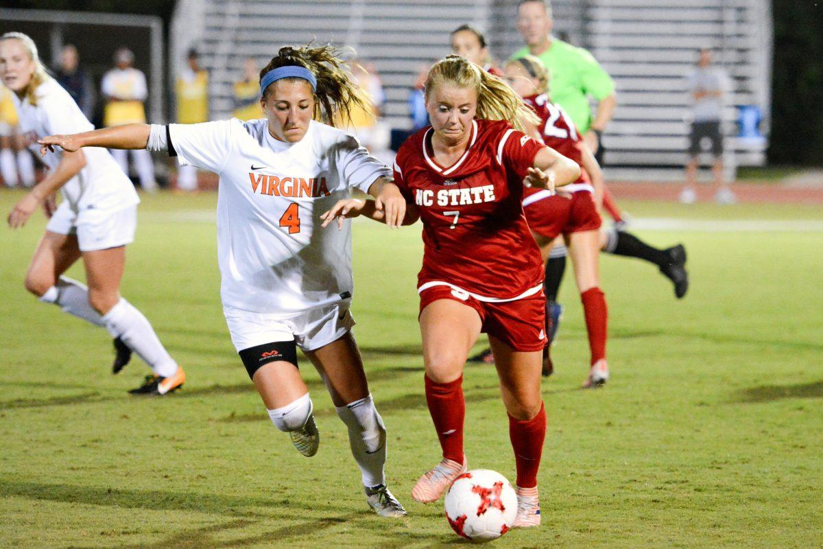 Sophomore midfielder Ricci Walking sprints ahead of a Virginia player to get the ball away from defense. The NC State women's soccer team tied Virginia 0-0 in double overtime at Dail Soccer Stadium on Friday, Sep. 15.