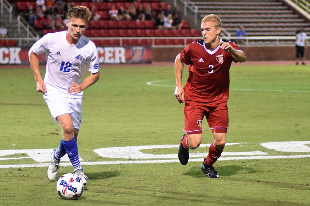 Senior defender Caleb Duvernay shadows senior midfielder Ben Chapal from UNC Asheville during the men's soccer game in Dail Soccer Stadium. Duvernay played for all 90 minutes of the Wolfpack's 3-0 win on Tuesday.