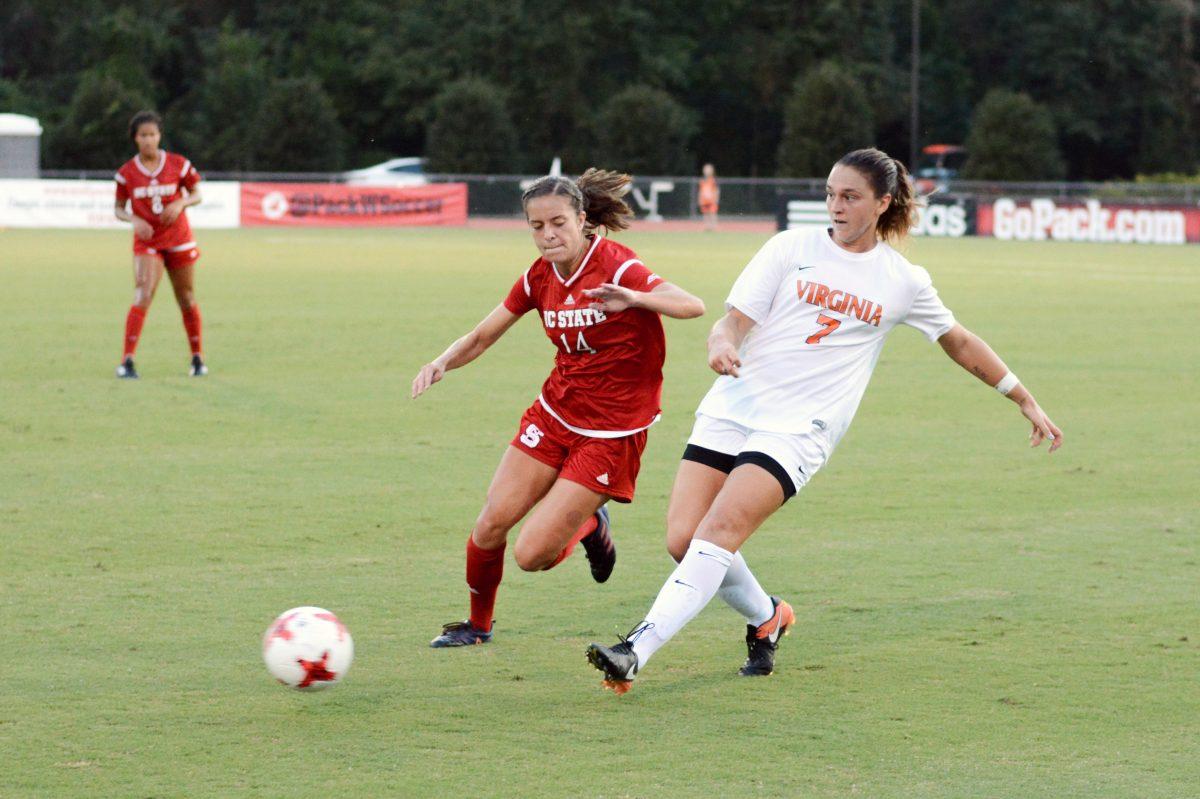 Junior midfielder Taylor Porter sprints ahead of a Virginia player to take back possesion of the ball. The NC State women's soccer team tied Virginia 0-0 in double overtime at Dail Soccer Stadium on Friday, Sep. 15.