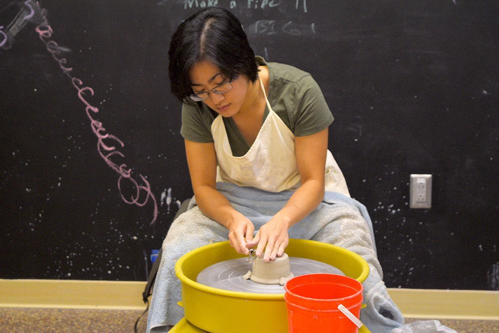 Stephanie Huang, a graduate student studying art and design, practices throwing a pot in her Intro to the Potter&#8217;s Wheel class at the Craft Center. The Craft Center has a wide variety of classes and workshops that students can attend to learn something new.
