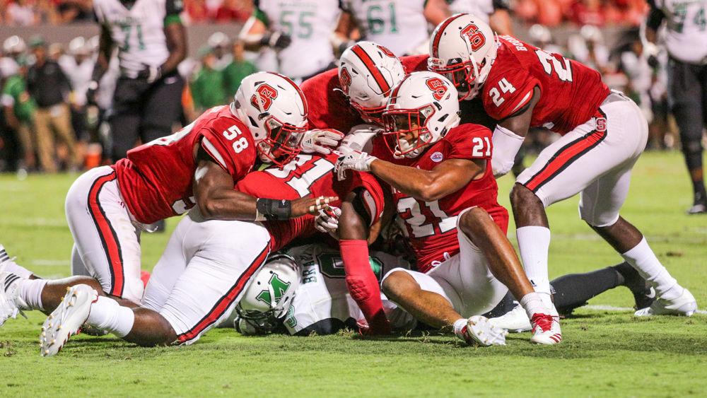 The Wolfpack defense wraps up Marhsall's Tyre Brady during the 37-20 win over Marshall on Saturday, Sept. 9, in Carter-Finley Stadium.