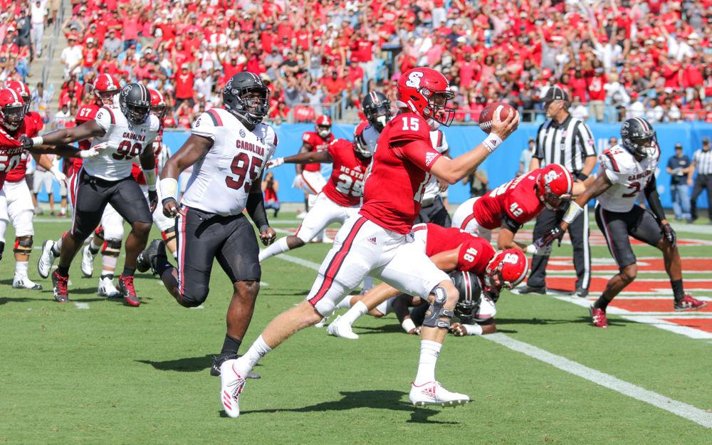 Redshirt graduate quarterback Ryan Finley carries the ball in on a QB sneak for the first Wolfpack points. Finley had a great offensive showing with 415 yards through the air while completing 70 percent of his passes. The Wolfpack fell 35-28 loss to South Carolina on Saturday Sept. 2 in the Bank of America Stadium for the Belk College Kickoff game.