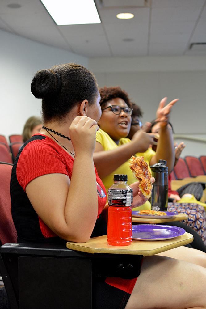 Nicole Williams, a fourth-year studying environmental science, watches Zuri Peterkin, a fifth-year studying wildlife science, make a point during movie trivia at a Disney Film Club meeting. The meeting took place in Riddick Hall on Thursday, Aug. 31. After trivia, the club members watched the movie "Moana."