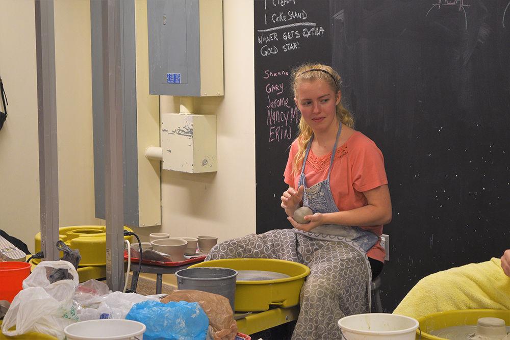 Jayme Currie, a third-year studying chemical engineering, prepares her clay to begin throwing a pot in her Intro to the Potter's Wheel class at the NC State Craft Center. The Craft Center has eight different studios open for student usage throughout the year.&#160;