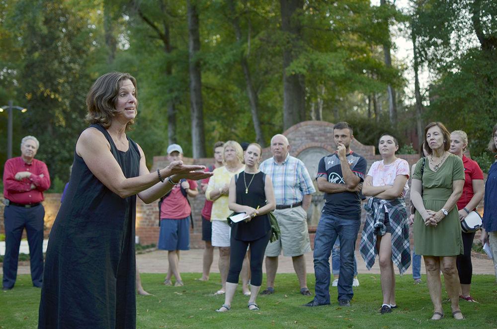 Captivated students watch Professor Anne Spafford's lively explanation of the gardens at the Gregg Museum of Art &amp; Design on Thursday. This event was hosted to raise awareness about pollinators as well as learn how gardening and architecture can intertwine.