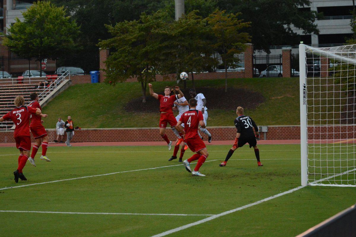 Junior defender Simon Blotko jumps up for a header as LIU Brooklyn players get closer to the goal. At the time this photo was taken the NC State men's soccer team was winning 1-0 against LIU Brooklyn at Dail Soccer Stadium on Friday, Sep. 1 until the game was suspended due to inclement weather.