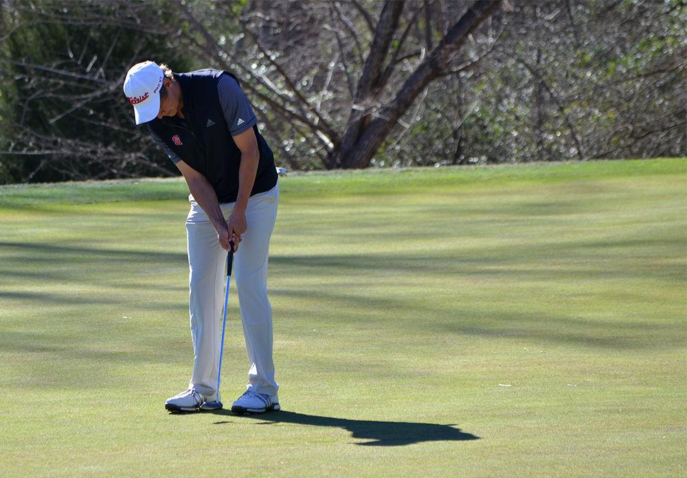 Nolan Mills Jr., a sophomore majoring in exploratory studies, successfully putts his ball into the hole during the second part of Heel/Pack Invitational at the Lonnie Poole Golf Course. In addition to both of the hosting schools, the invitational also featured Duke, Liberty, UNC-Charlotte, Wake Forest, UNC-Greensboro, Limestone and Campbell.