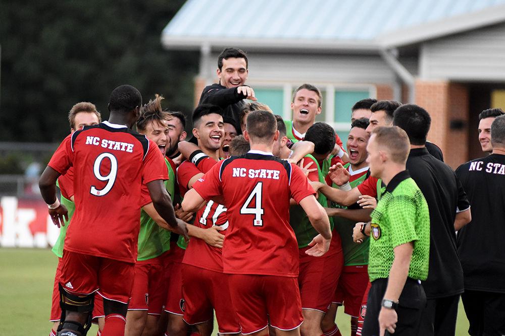 The NC States Men's soccer team congratulates their teammate after he scored a game against UNC Asheville. The team would go on to win at home in Dail Soccer Stadium 3-0 on Tuesday.