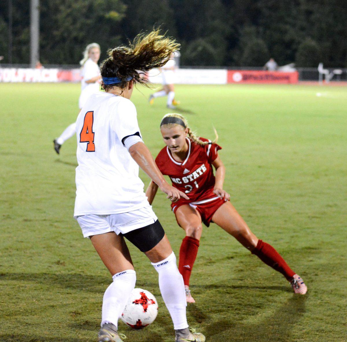 Sophomore midfielder Paige Griffiths looks for a way to steal the ball from a Virginia player. The NC State women's soccer team tied Virginia 0-0 in double overtime at Dail Soccer Stadium on Friday, Sep. 15.