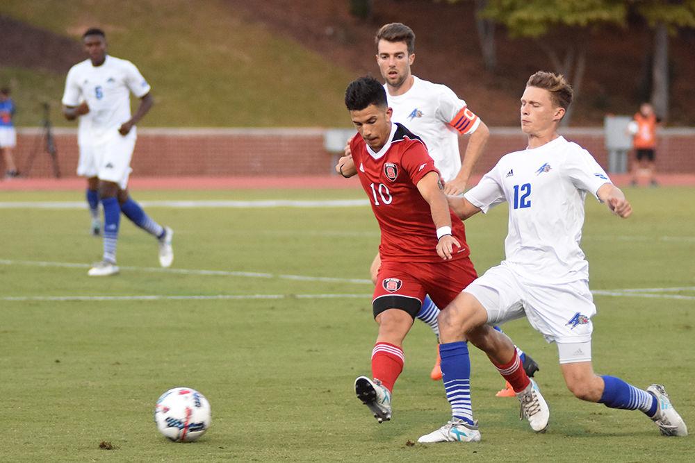 Freshman forward David Loera sprints past two defenders during the game against UNC Asheville. The Wolfpack won 3-0 in Dail Soccer Stadium on Tuesday.