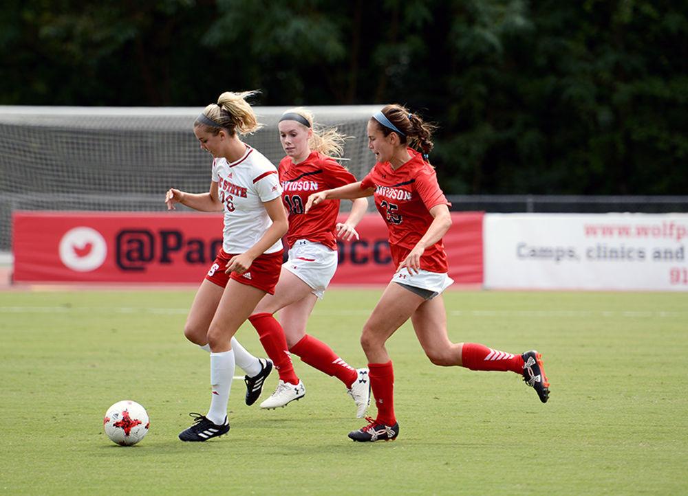 Freshman forward Tea Smith sprints with the ball ahead of two Davidson players. The NC State women's soccer team beat Davidson 4-0 at Dail Soccer Stadium on Sunday, Sept. 10.