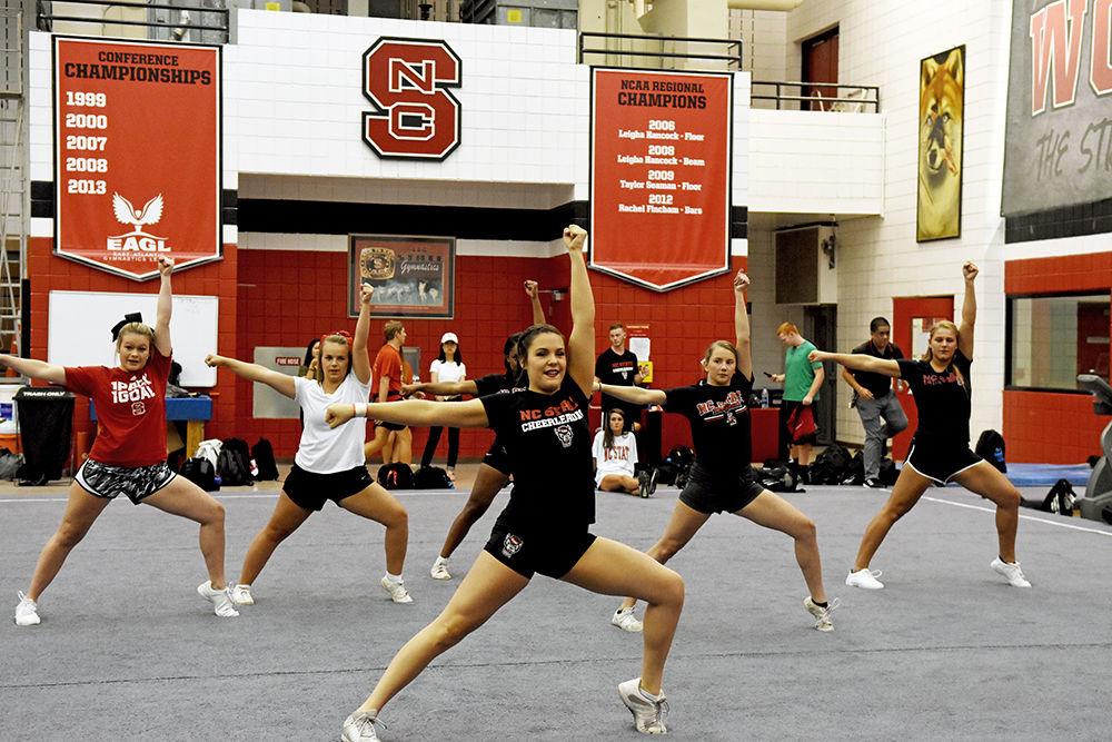 Rachel Magoon, a third-year exploratory studies student, teaches prospective members of the 2017 Fall COED Cheerleading team for the upcoming football season on Wednesday, Aug. 30 in Carmichael Gym. Prospective members joined current members of the team in stunting, tumbling and jumping.