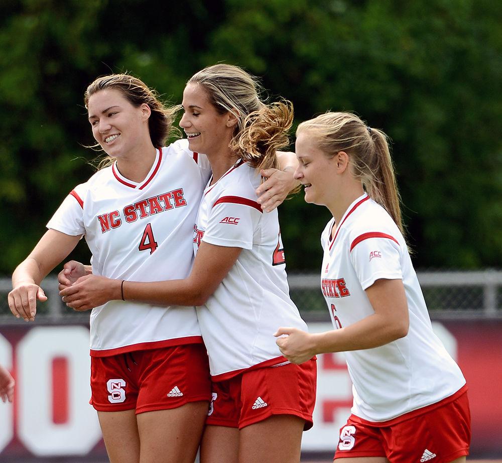 Junior defender Hanna Keogh, redshirt-senior Rachel Cox and freshman defender Lulu Guttenberger celebrate a goal by Cox. The NC State women's soccer team beat Davidson 4-0 at Dail Soccer Stadium on Sunday, Sept. 10.
