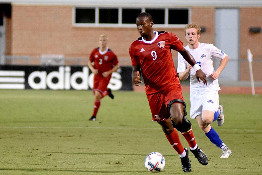 Senior forward Ade Taiwo dribbles the ball up-field during the game against the UNC Asheville Bulldogs. The Wolfpack would go on to win the game 3-0 in Dail Soccer Stadium on Tuesday.