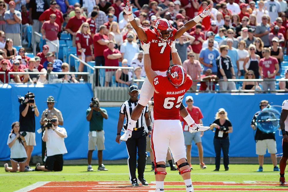 Junior running back Nyheim Hines is lifted by redshirt junior offensive guard Garrett Bradbury after scoring a touchdown. Despite Hines' 192 all-purpose yards, the Wolfpack lost the game 35-28 in Bank of America Stadium. The game, which was attended by 50,367 was played in Charlotte, NC on Saturday, Sept. 2.