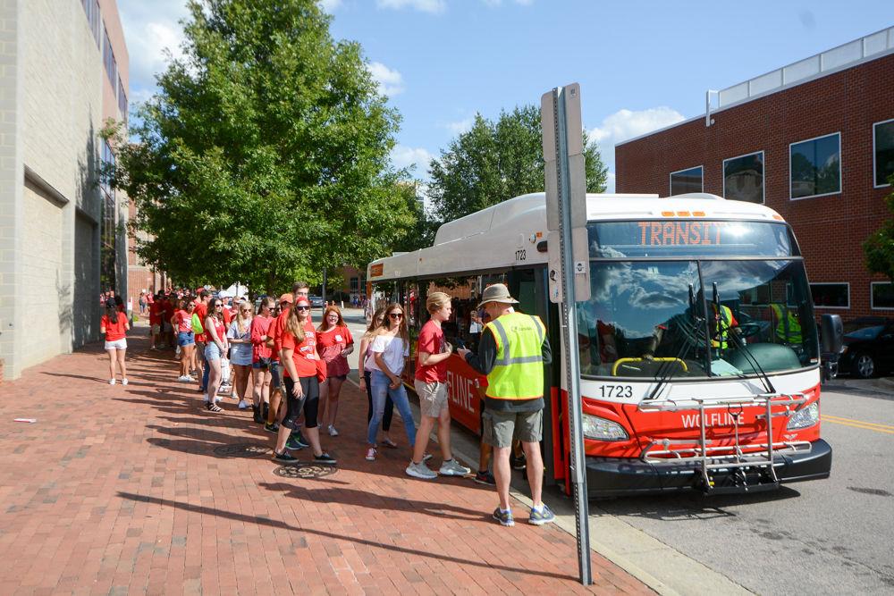 State students line the brick walkway down Cates Ave eagerly awaiting the arrival of the Wolfline Red Terror buses. This game kicked off at 6pm in Carter-Finley Stadium against Marshall on Saturday, Sept 9.