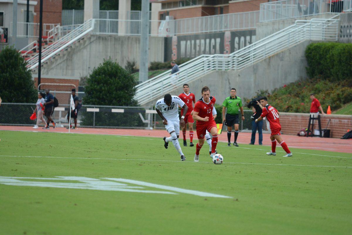 Junior defender Simon Blotko runs upfield as LIU Brooklyn player tries to reclaim the ball. At the time of this photo the NC State men's soccer team was winning against LIU Brooklyn 1-0 at Dail Soccer Stadium on Friday, Sep. 1 until the game was suspended due to inclement weather.