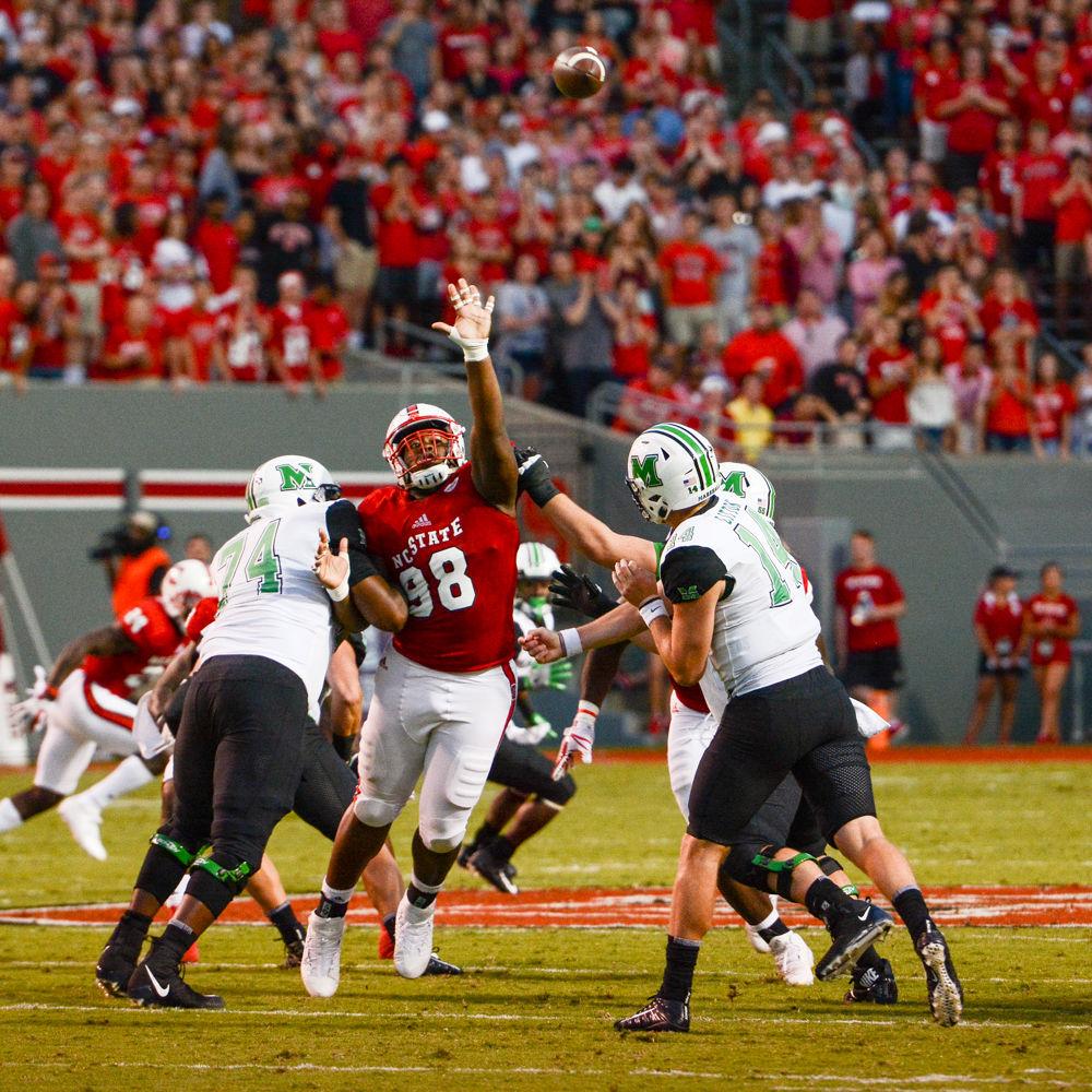 Adam Boselli, a freshman tight end for State, attempts to block a pass made by Chase Litton, Marshall's junior quarterback. This game took place in Carter-Finley Stadium on Sat Sept 9, 2017 at 6pm.