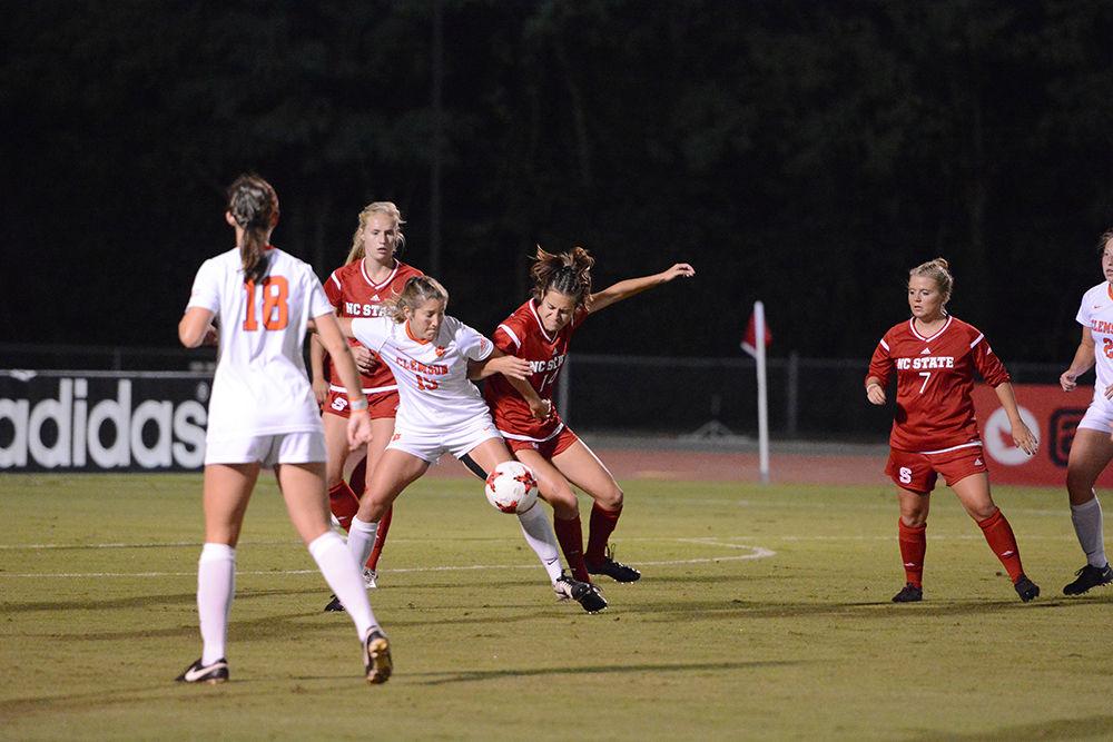 Junior midfielder Taylor Porter battles for the ball against a Clemson defender during the game. The Wolfpack would go on to win the game 1-0 in Dail Soccer Stadium on Thursday.