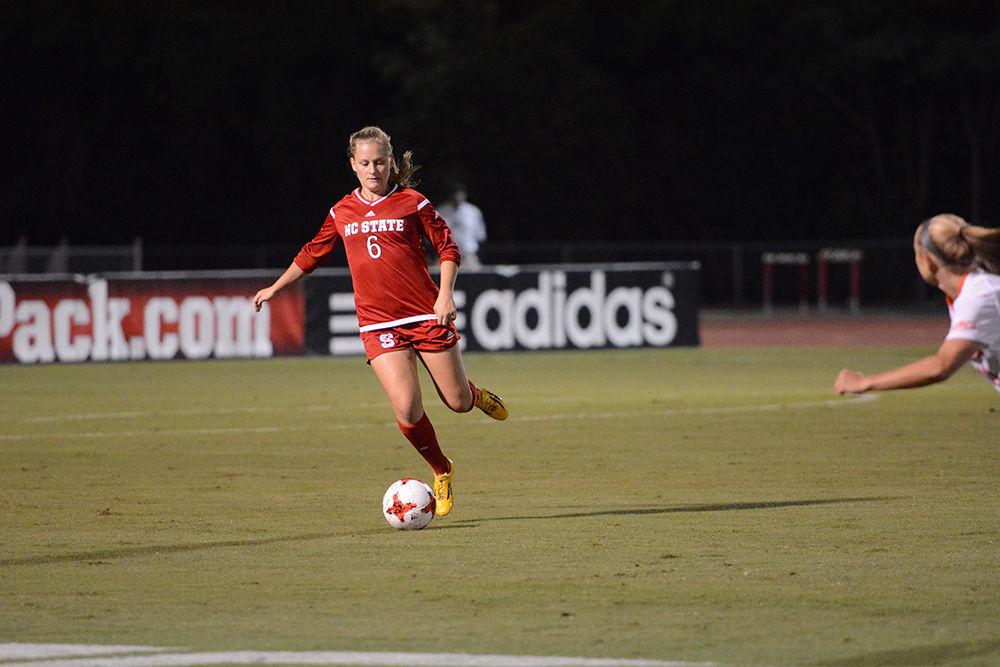 Freshman defender Lulu Guttenberger passes the ball during the game against the Clemson Tigers. The Wolfpack would go on to win the game 1-0 in Dail Soccer Stadium on Thursday.