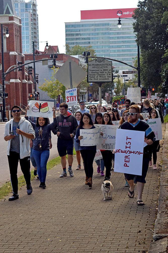 Rally members defend DACA by marching to Halifax Mall in downtown Raleigh on Sunday. The march was in reaction to Trump's decision to rescind the program that protected children from deportation. Several speakers, including Congressman David Price, condemned Trump's actions, while people who depend on DACA told their stories.