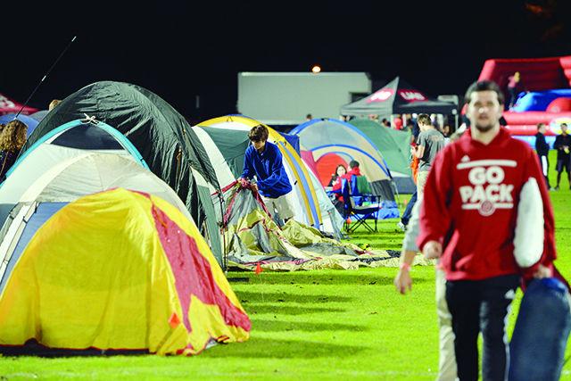 A student is seen setting up his tent as he prepares for the rest of the evening during Campout. This event was organized by Union Activities Board and it took place on Miller field on Friday, 17th October. Campout, an NC State tradition, takes place every year where students gather, set up their tents, and enjoy on inflatable rides. This year, every student registered for the event earned 6 loyalty points to win tickets to a football game. Banu Ganeshan.