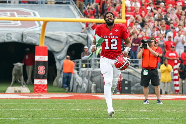 Jacoby Brissett walks with his rose for Senior Day before the game against the UNC Tarheels on November 28, 2015 at Carter-Finley Stadium.