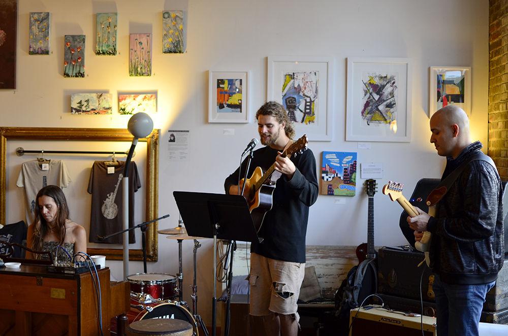 A band made up of employees of art coffee shop Lucky Tree performs in their coffee shop as part of Art it Up! Hillsborough Street on Saturday. Guitar player Bauback Yeganeh said "We're a few friends who like playing music together to relax and have fun."