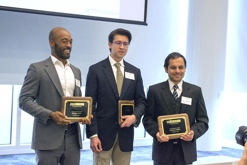 The winners of the Three-Minute Thesis Competition stand together with their plaques for a group photo in Hunt Library on Tuesday. Tyler Allen won the second-place award of $750, Paul Enriquez won the first-place award of $1,000 and Ashish Kapoor won the "People's Choice" award of $500.