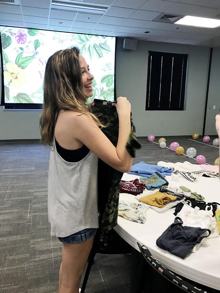 Kelly Dolan, fourth-year studying fashion and textile management picks out items of clothing at Clothing Swap, an event where students could swap their used clothes with other students in the College of Textiles Convocation center on Wednesday.