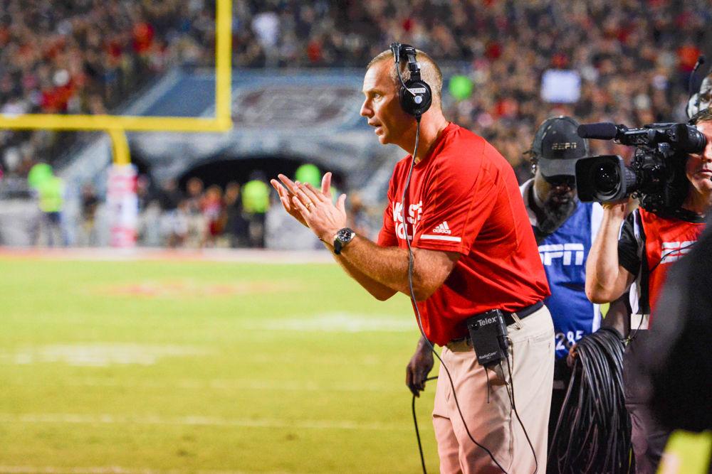 Head coach Dave Doeren congratulates the Wolfpack after their interception, which was returned for a touchdown. Under Coach Doeren, the NC State Wolfpack would win 39-25 in Carter Finley Stadium on Thursday, Oct 5.