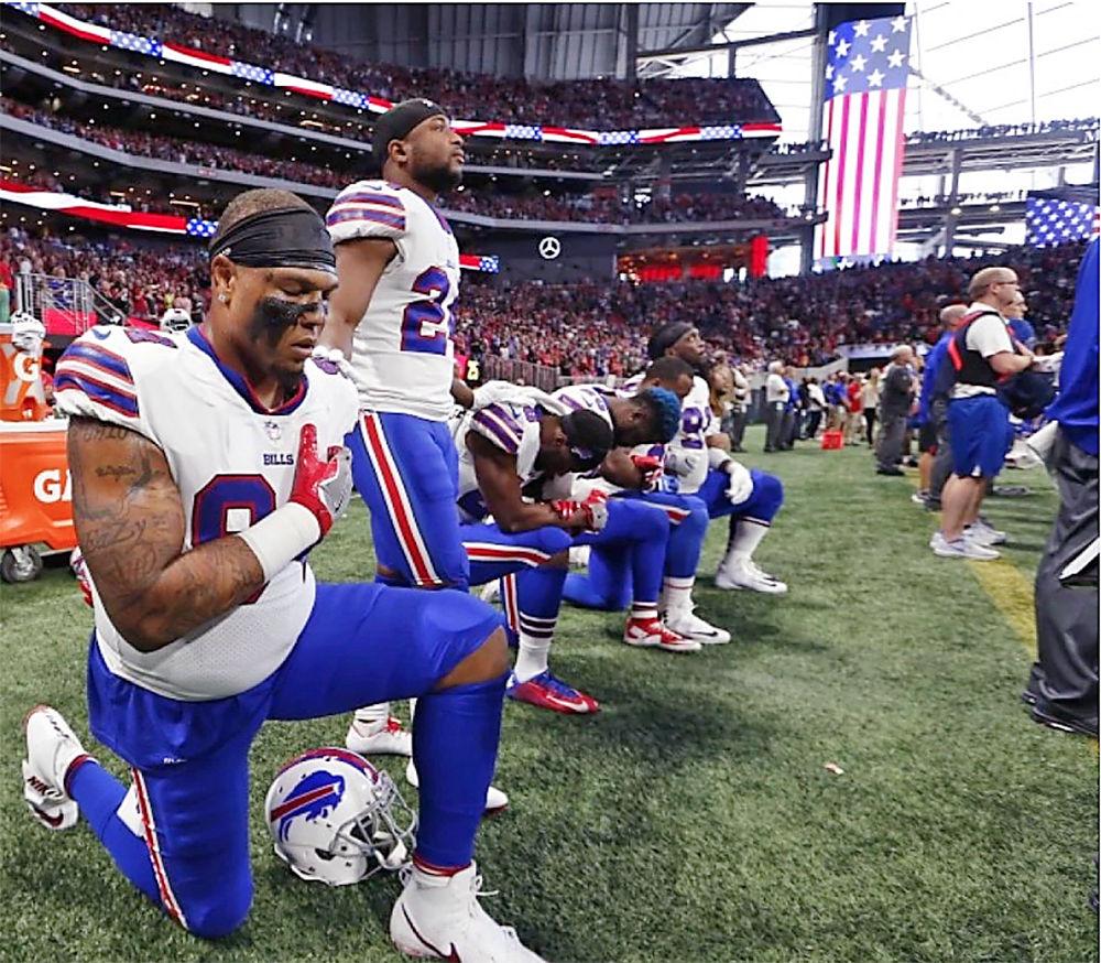 Jerel Worthy and Buffalo Bills teammates take a knee during the national anthem before an NFL game against the Atlanta Falcons in Atlanta on Oct. 1.