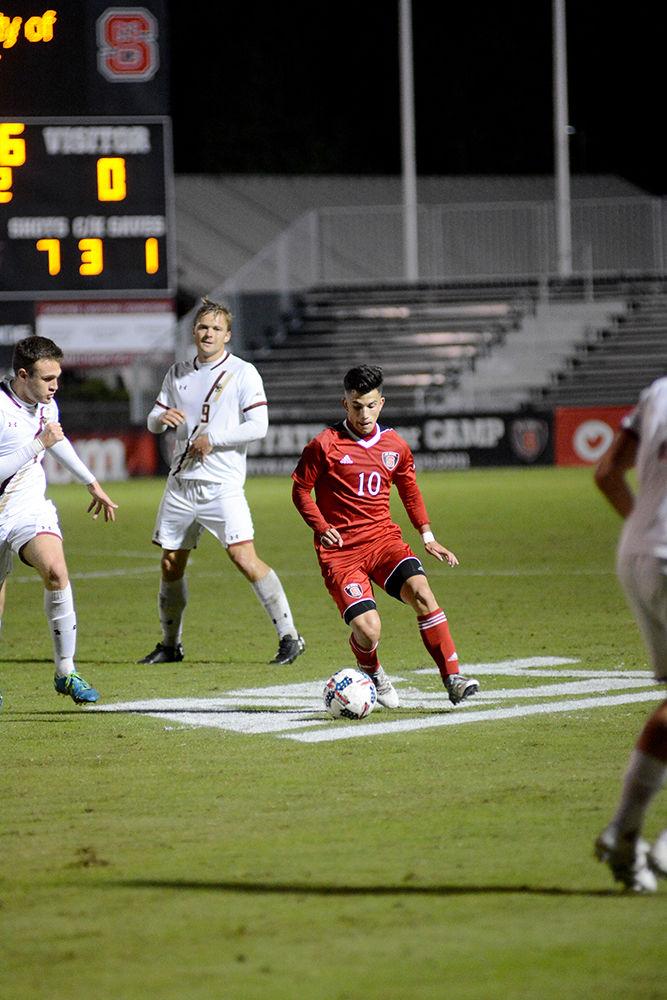 Freshman forward David Loera maneuvers between defenders during the NC State vs. Boston College men's soccer game at Dail Soccer Stadium on Friday, Oct. 27. The Wolfpack drew with the Golden Eagles after overtime with a score of 0-0.