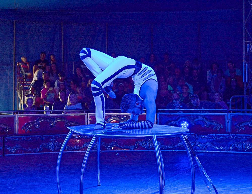 Kevin Sadrak performs a contortionist act in the International All-Star Circus at the NC State Fair Friday. The International All-Star Circus also consisted of a quick-change act, a unicyclist act, a trampolinist act and a motorcyclist act. The circus was among the many attractions at the 150th Annual State Fair this year.
