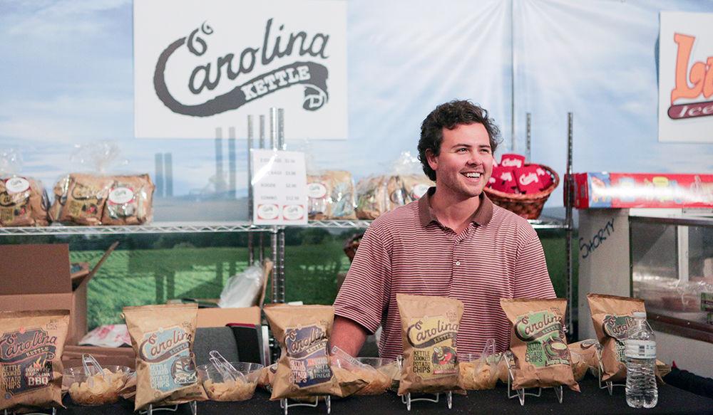 Josh Monahan, an NC State alumnus, oversees his stand at the North Carolina State Fair on Oct. 17. Monahan started Carolina Kettle as a subsidiary of his company, 1 in 6 Snacks, which donates a portion of their proceeds to local food banks.