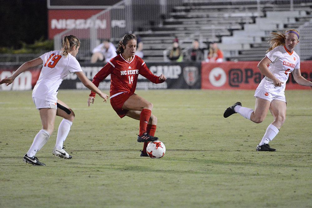 Junior midfielder Taylor Porter dribbles through defenders against Clemson. The Wolfpack would go on to win the game 1-0 in Dail Soccer Stadium on Thursday.