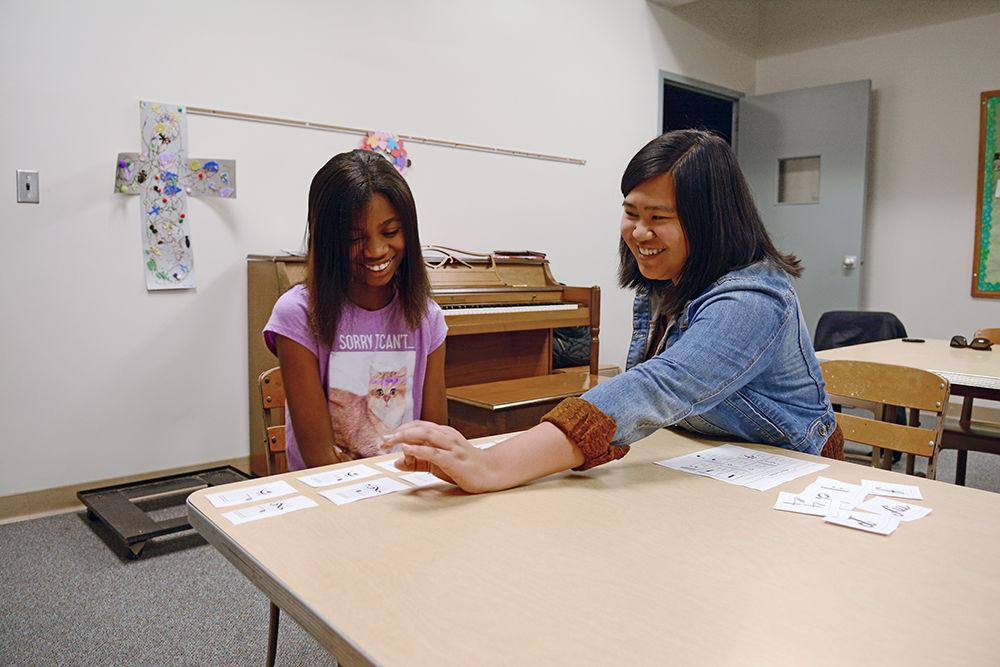 Gabbie Consing, a second year studying psychology teaches Ke'mora Poore the fundamentals of reading piano music on Tuesday at Holy Trinity Lutheran Church. Gabbie is a part of the group Musical Empowerment, which seeks to serve Raleigh youth who may not have access to music lessons without their help. The program provides free instruments, books, and trainings to the participants.