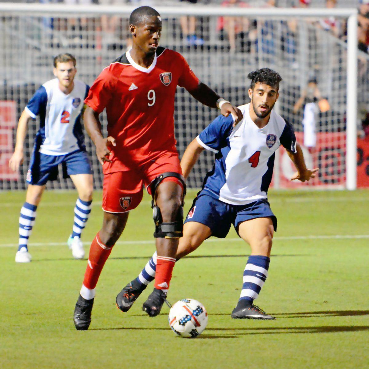 Senior forward Ade Taiwo carries the ball during the game against the Belmont Bruins. The Wolfpack would go on to win the game 3-0 in Dail Soccer Stadium on Oct 3.